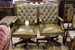 Pair tan deep buttoned and studded leather swivel desk chairs