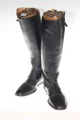 Pair of black leather riding boots with trees
