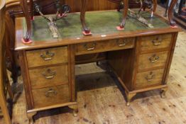 Early 20th Century walnut seven drawer pedestal desk on cabriole legs,