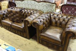 Brown deep buttoned leather two seater Chesterfield settee,