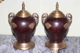 Pair of bronze twin handled and lidded urns