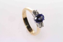 18 carat yellow gold, oval tanzanite and round brilliant diamond three-stone ring,