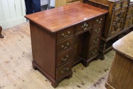 Mahogany nine drawer kneehole desk with inverted cupboard door,