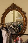 Oval gilt framed bevelled wall mirror