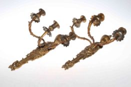 Pair of ornate three branch gilt metal wall sconces