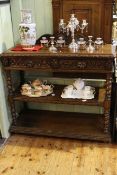 Carved oak three tier buffet, having two drawers with lion masks and twist pillars,