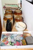 Stoneware storage jars, three pottery jelly moulds, figure decanter, buttons,