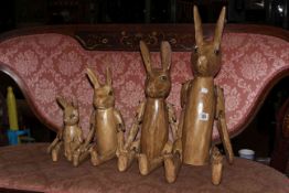 Set of four jointed wooden hares