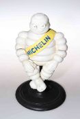Cast revolving Michelin Man on stand
