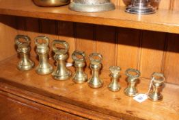 Eight brass bell weights