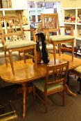 Pine twin pedestal extending dining table and four chairs including two carvers