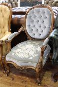Victorian carved mahogany open armchair with serpentine front seat in floral and buttoned fabric
