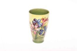 Moorcroft Pottery beaker decorated with spring flowers on yellow ground