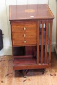Edwardian inlaid mahogany two tier revolving bookcase having three small drawers