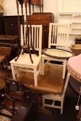 Oak draw leaf dining table, four painted rail back dining chairs,