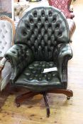 Deep buttoned and studded green leather swivel desk chair