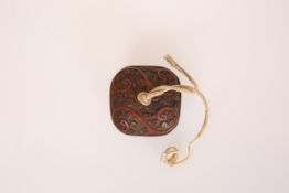 A CINNABAR LACQUER NETSUKE, two-part, of cushioned square shape.