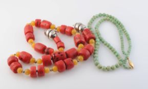 A LARGE CORAL BEAD NECKLACE, formed of twenty-five graduating cylindrical coral beads,
