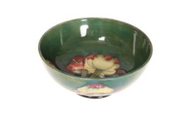 A WALTER MOORCROFT BOWL IN THE CLAREMONT PATTERN, circular footed form,
