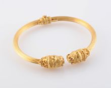 A GOLD BANGLE BY LALAOUNIS, the hinged mount of moulded metal detailing to the entirety,