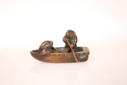 A JAPANESE WOOD NETSUKE, 19th Century, of two rabbits in a boat, each with inlaid eyes,
