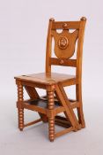 A VICTORIAN MAHOGANY METAMORPHIC CHAIR, hinged to form library steps, carved with lion mask.