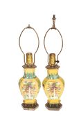 A PAIR OF CHINESE YELLOW GROUND VASES, MOUNTED AS LAMPS, each of faceted baluster form,