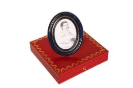 A CARTIER PHOTOGRAPH FRAME, oval with gilt speckled deep blue enamel surround, in original box.