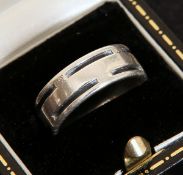 GEORG JENSEN, A DANISH STERLING SILVER RING, with spaced inset black bands,