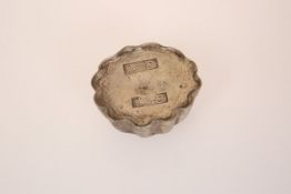 A CHINESE WHITE METAL TOKEN/WEIGHT, cast as a bowl, the well with a panel of calligraphy.