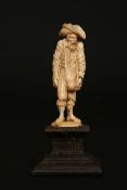 A CONTINENTAL IVORY FIGURE, 18TH OR 19TH CENTURY, carved as a ragged beggar, probably South German,