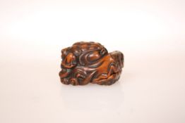 A JAPANESE WOOD NETSUKE OF A SHISHI HEAD, the scowling face with hinged jaw,