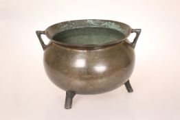 A BRONZE CAULDRON, PROBABLY 18TH CENTURY, with angular handles and everted rim,