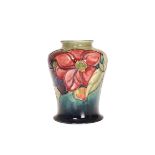 A WALTER MOORCROFT VASE IN THE CLEMATIS PATTERN, of shouldered ovoid form,