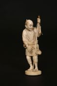 A JAPANESE IVORY OKIMONO, MEIJI PERIOD, carved as a fisherman, unsigned.