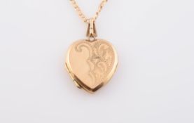 A GOLD LOCKET PENDANT, the pendant shaped as a heart with engraved detailing,