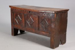 A 17TH CENTURY OAK COFFER, with carved rail and three carved panels. 66.