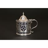 A GEORGE III SILVER MUSTARD POT, London 1786, with domed hinged cover and bright-cut decoration. 8.