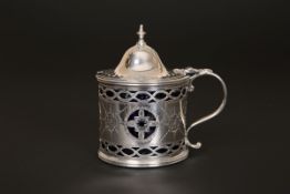 A GEORGE III SILVER MUSTARD POT, London 1786, with domed hinged cover and bright-cut decoration. 8.