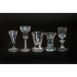 A GROUP OF FIVE 18th/19th CENTURY GLASSES, comprising: two firing glasses, one of trumpet form,