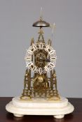 A VICTORIAN BRASS SINGLE FUSEE SKELETON CLOCK, in the 'Gothic' taste,