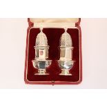 A PAIR OF GEORGE V SILVER PEPPER POTS, Goldsmiths & Silversmiths Co, London 1926, in a fitted case.