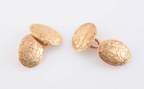 A PAIR OF GOLD CUFFLINKS, each oval plaque with engraved floral detailing,