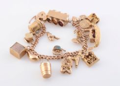 A 9 CARAT GOLD CHARM BRACELET, with various charms including poodle, binoculars, tankard,