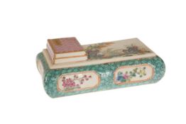 A CHINESE FAMILLE ROSE PORCELAIN PEN REST, pillow shaped, enamel painted with flowers and rockwork,