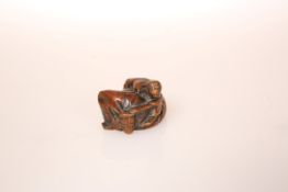 A JAPANESE WOOD NETSUKE OF A MONKEY TRAINER, possibly late 18th Century,