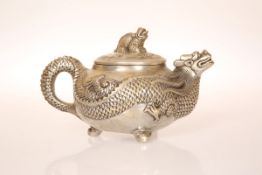 A CHINESE WHITE METAL TEAPOT, cast with a dragon,