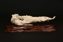 A JAPANESE CARVED IVORY GROUP OF FIGHTING LIONS, MEIJI PERIOD, modelled in ferocious combat,