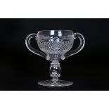 A LATE 19th CENTURY CUT-GLASS LOVING CUP, the bowl with a band of fluting above diamond-cut panels,