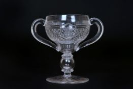 A LATE 19th CENTURY CUT-GLASS LOVING CUP, the bowl with a band of fluting above diamond-cut panels,